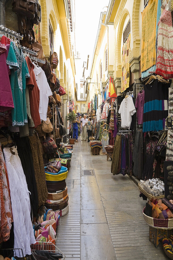 Shopping boutiques along an alleyway at an Arab souk in Granada, Spain, Europe.
