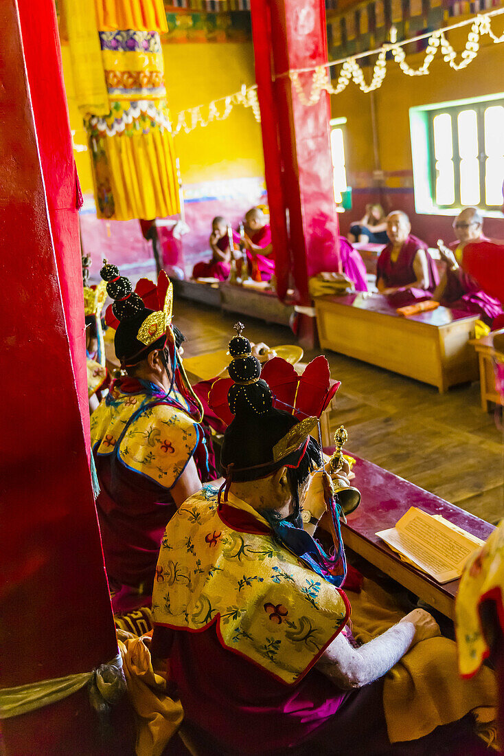 Buddhist monks of the Yellow Hat sect praying at the Diskit Monastery, Nubra Valley, Ladakh, Jammu and Kashmir State, India.