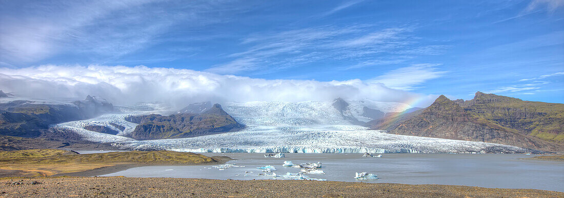 A Rainbow Over The Glacier Down The Mountain Off Of The Vatnajorkull Ice Cap, Skaftafell National Park, Iceland