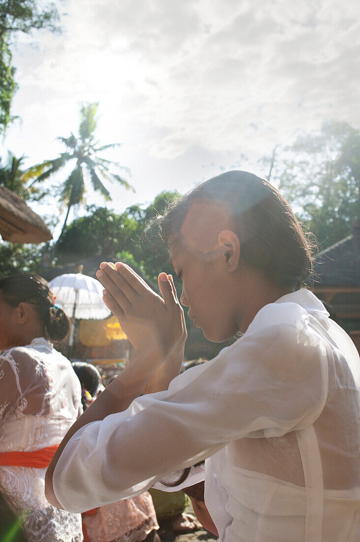 'Young Woman Praying During Kuningan Festival; Bali, Indonesia'