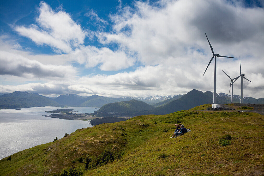 Hikers Enjoying A Sunny Afternoon Walk Near The Wind Turbines, Part Of The Pillar Mountain Wind Project, Operated And Owned By The Kodiak Electric Association, Pillar Mountain, Kodiak Island, Southwest Alaska, Summer