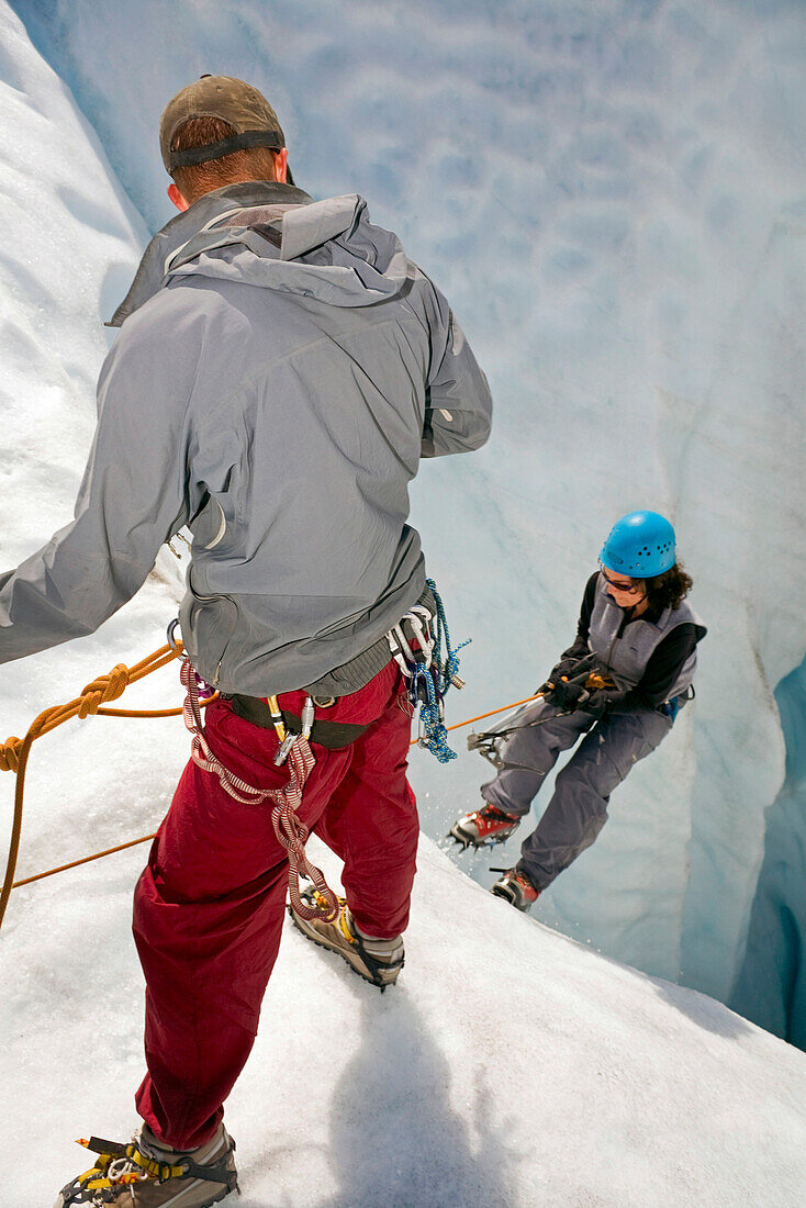 Woman Being Belayed Into Moulin On The Root Glacier Near Kennicott Southcentral Alaska Summer