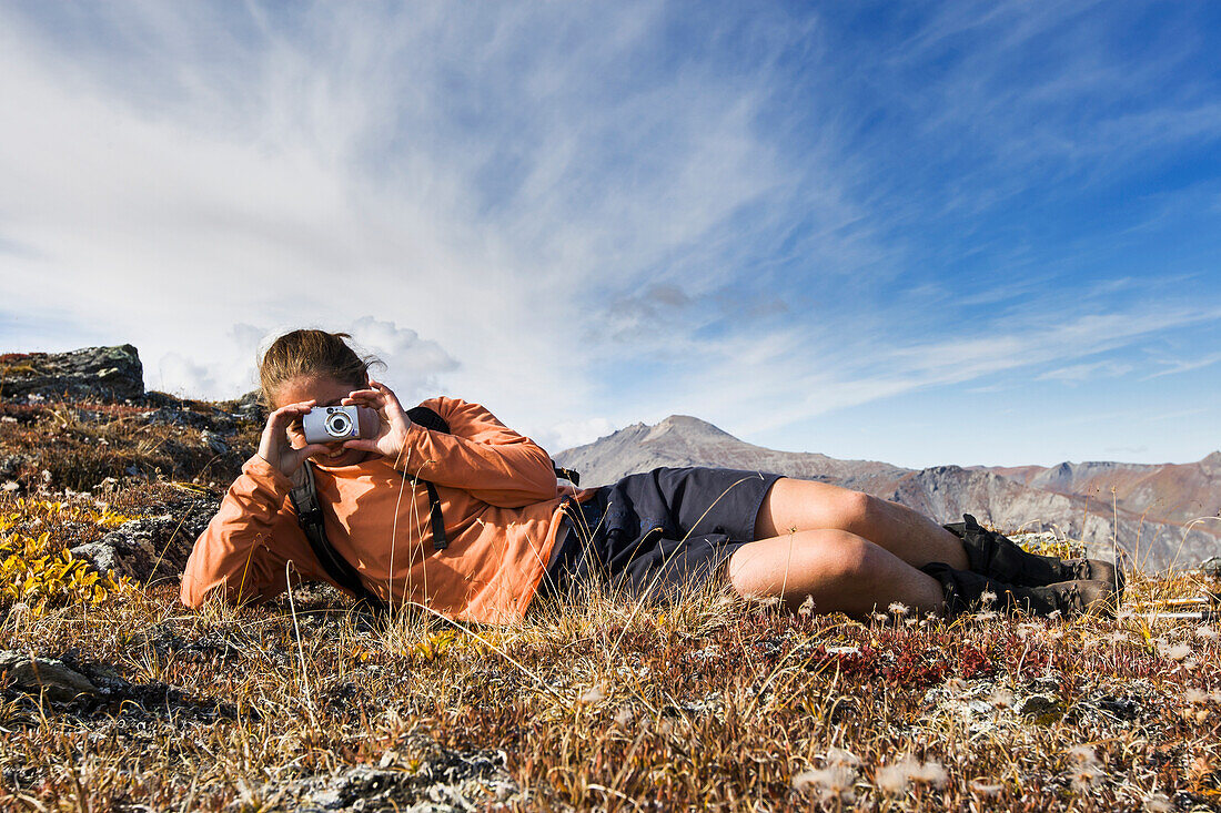 Hiker Stops To Take A Picture Near Noatak River In The Brooks Range, Gates Of The Arctic National Park, Northwestern Alaska, Above The Arctic Circle, Arctic Alaska, Summer.