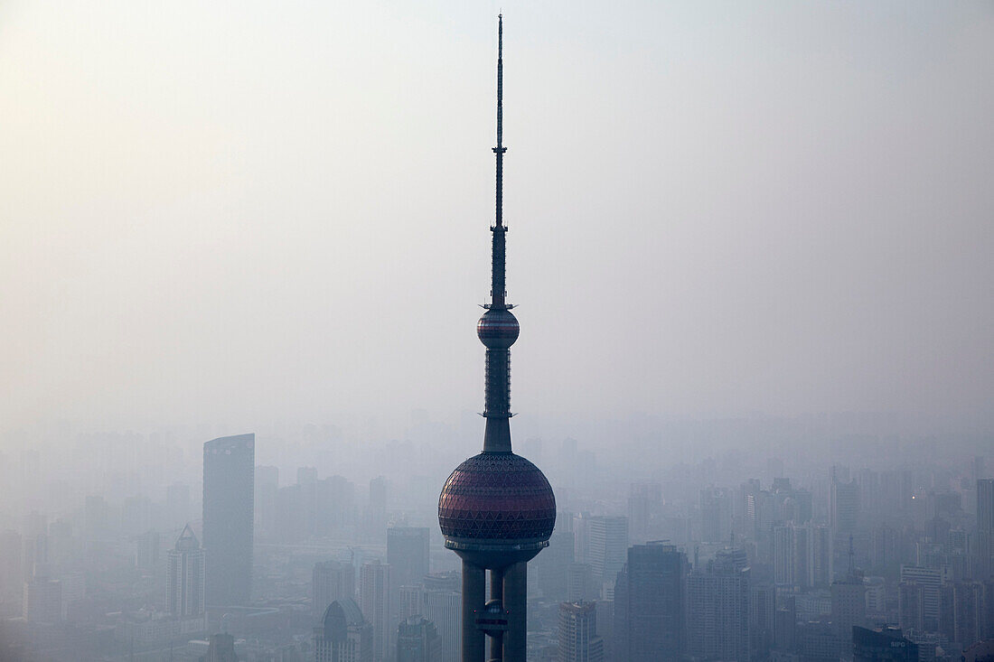 Oriental Pearl Tower over misty cityscape, Shanghai, China