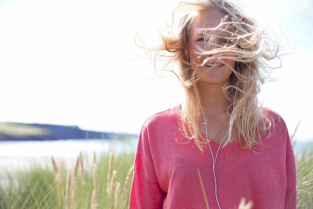 Portrait of woman with messy blonde hair, Wales, UK