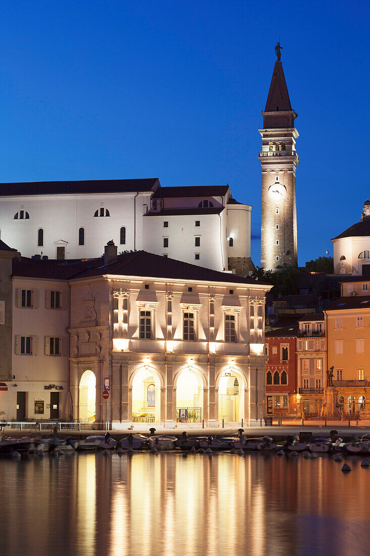 Waterfront buildings at the harbour and bell tower of Cathedral of St. George, Piran, Istria, Slovenia, Europe