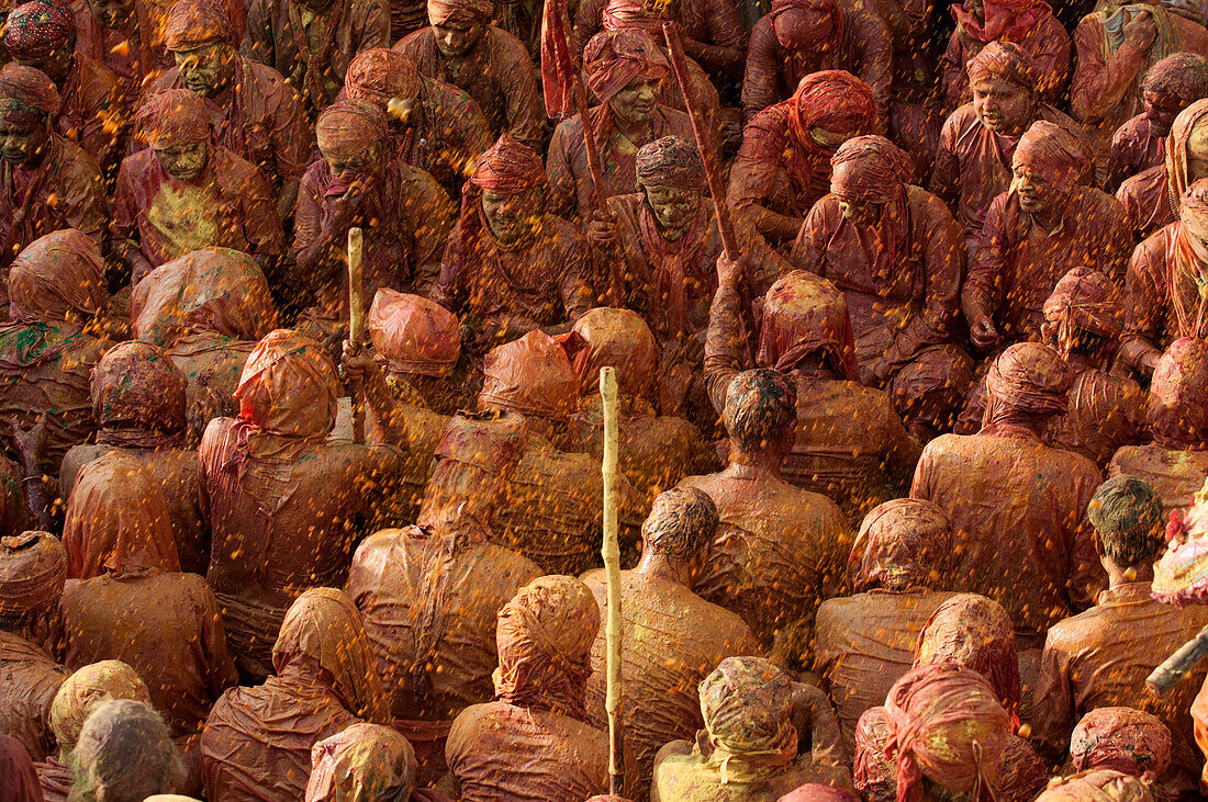 Throwing red colors at the Nandgaon temple during Holi festival celebration, Nandgaon, Mathura, India
