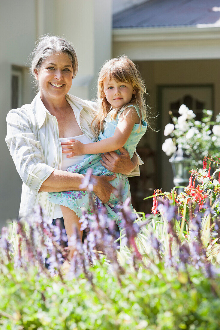 Grandmother and granddaughter admiring flowers, Cape Town, Western Cape, South Africa