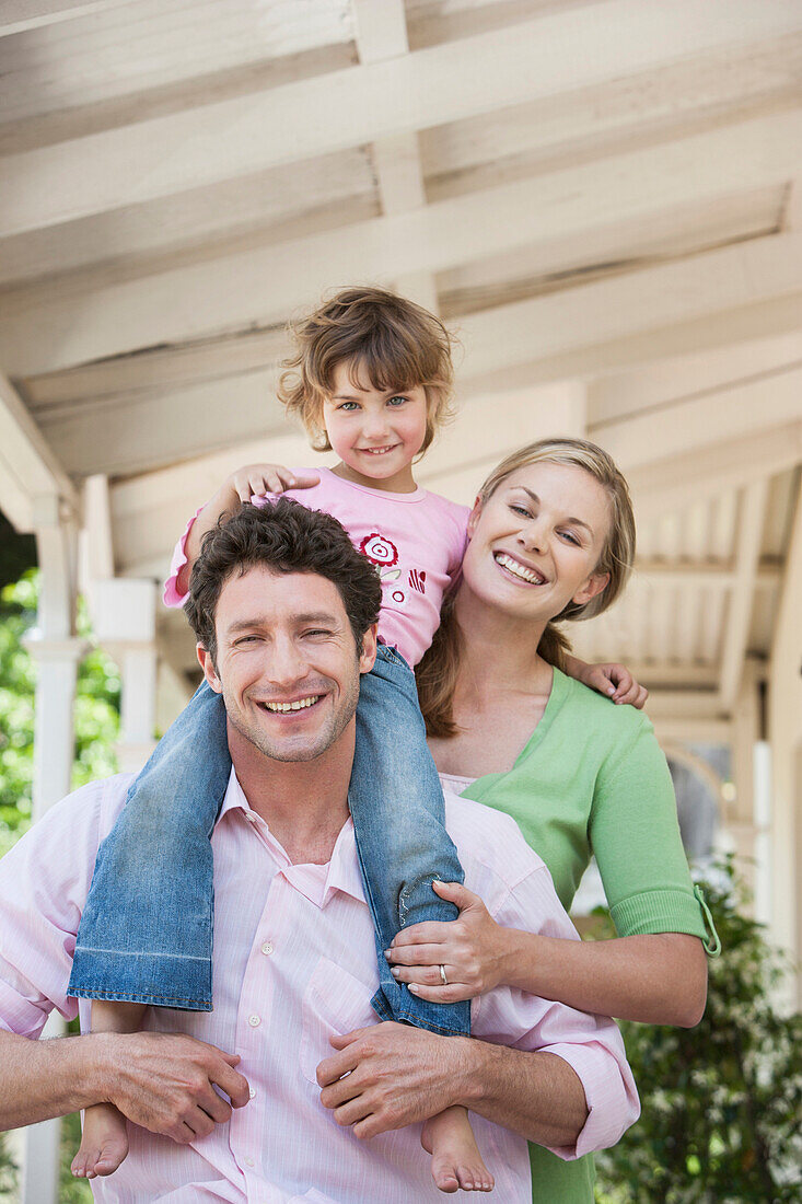 Caucasian family smiling on porch, Cape Town, Western Cape, South Africa