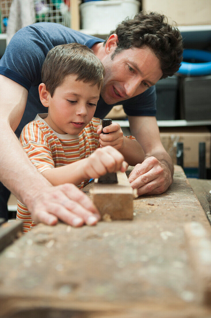 Caucasian father and son working in woodshop, Cape Town, Western Cape, South Africa