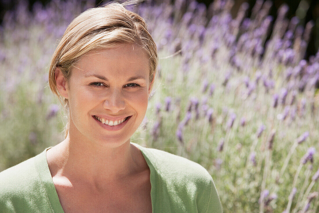 Caucasian woman smiling in lavender field, Cape Town, Western Cape, South Africa