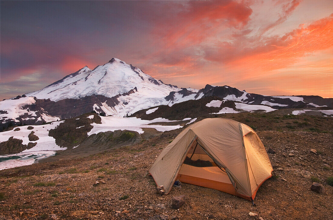 Tent at campsite in snowy mountain landscape, North Cascades, Washington, United States