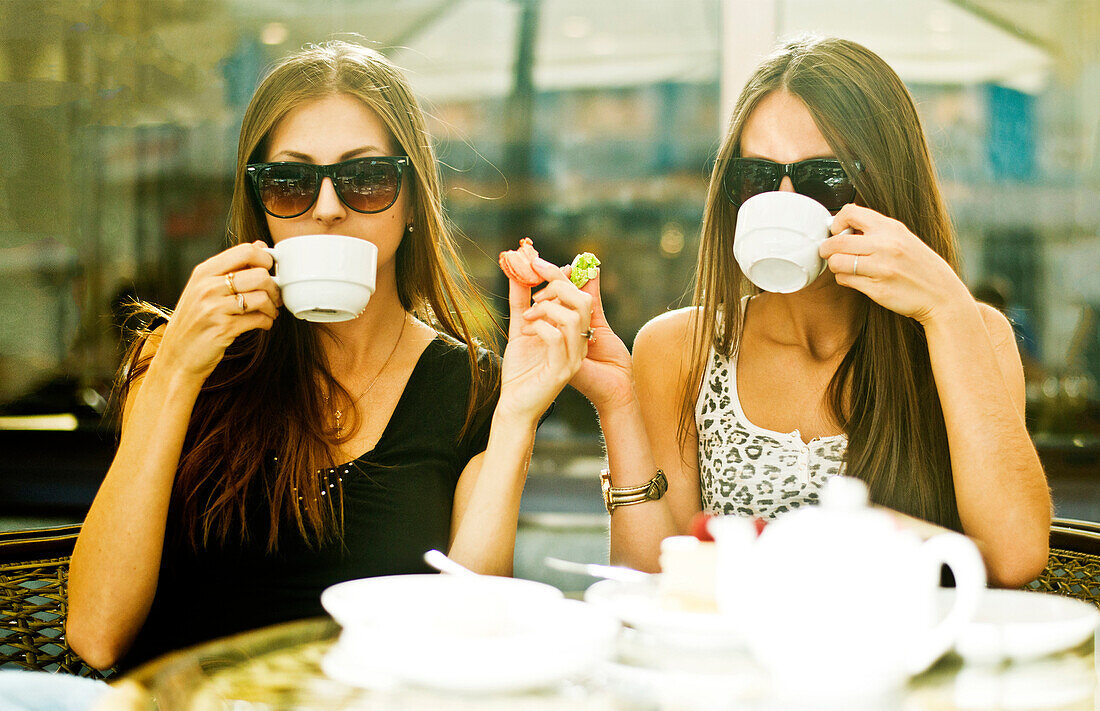 Women having coffee together at sidewalk cafe, Ekaterinburg, Swerdlovsk, Russia