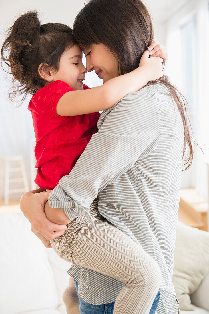 Hispanic mother and daughter hugging, Jersey City, New Jersey, USA