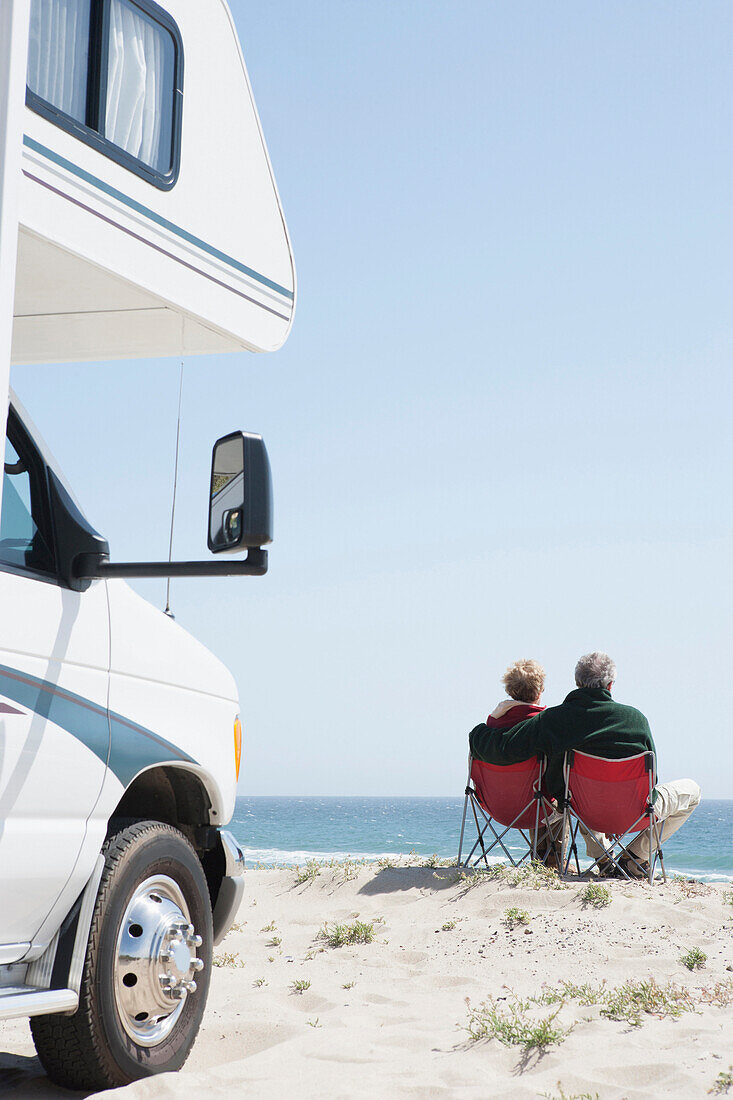 Senior Caucasian couple in lawn chairs overlooking ocean, Los Angeles, United States, United States