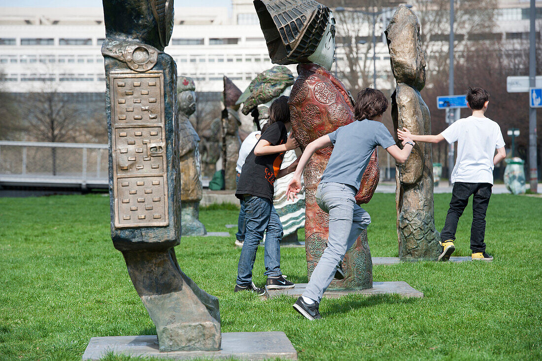 'France. Paris 12th district. Park of Bercy, Childen playing among statues '' The children of the world '' of Rachid Khimoune'