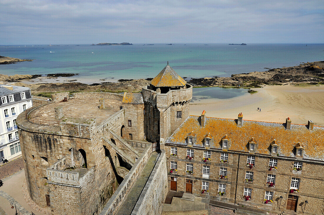 France, Brittany, Saint Malo, partial view of the castle with its tower and the small donjon, city hall on the right.