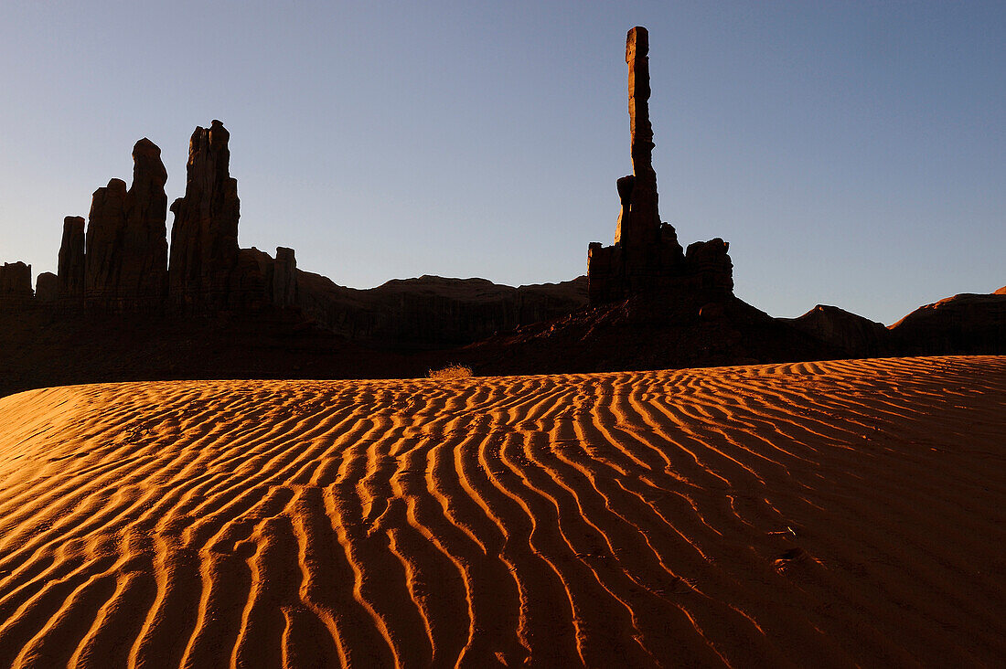 TOTEM POLE AND YEI BI CHEI ON SAND DUNE, MONUMENT VALLEY NAVAJO TRIBAL PARK, ARIZONA, USA