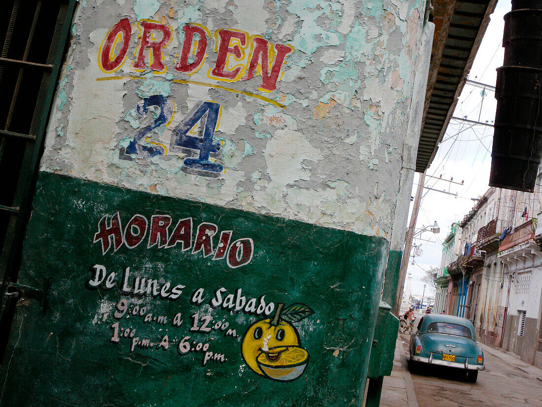 Opening times painted on wall, Cuba, Caribbean