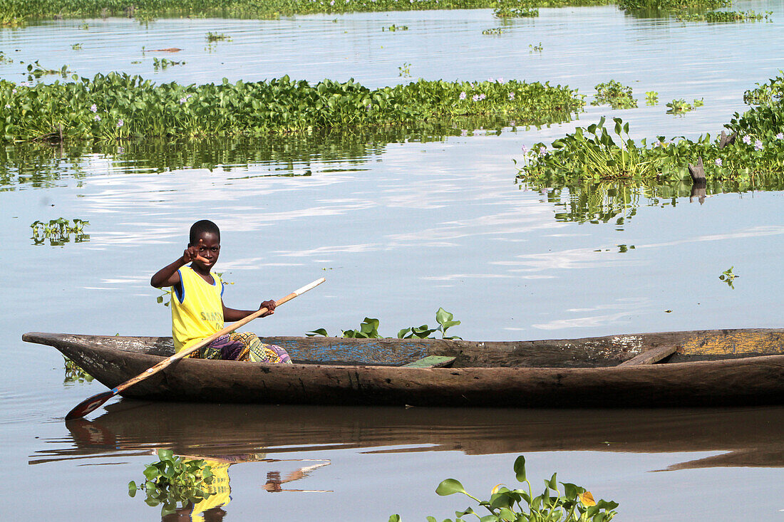 African children in a canoe. Lakeside town. Lake Nokoue. Ganvie. Benin.