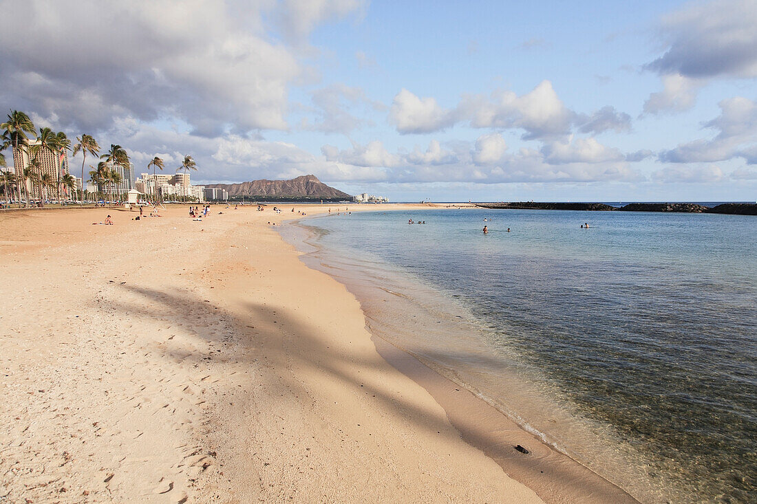 'Shadow of a palm tree on the beach along the coast; Honolulu, Oahu, Hawaii, United States of America'
