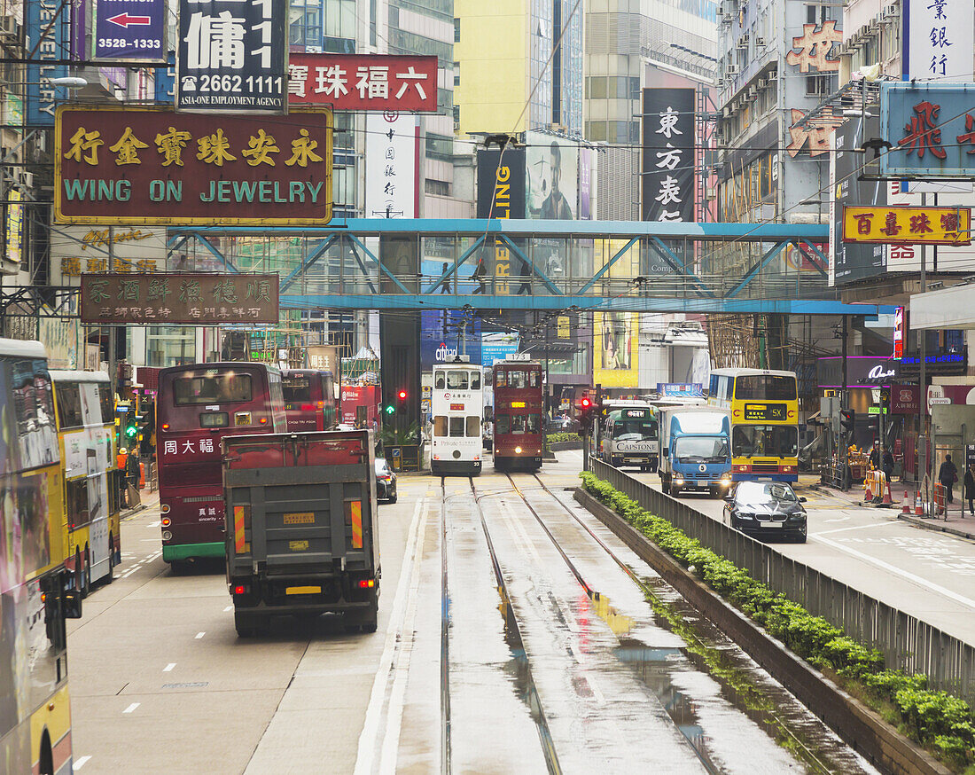 'City Street With Signs And Buses And Trams; Hong Kong, China'