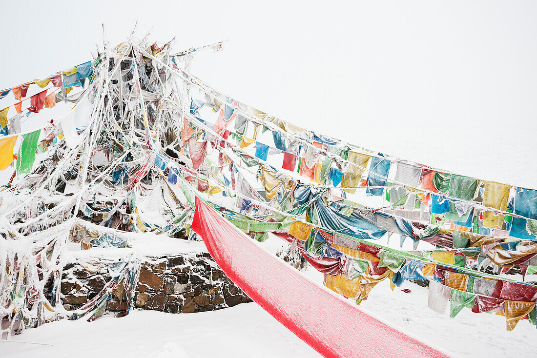 'Five-Color Prayer Flags With Mantras At The Snowed In High Mountain Pass, Tibet Stupa; Tibet, Sichuan, China'