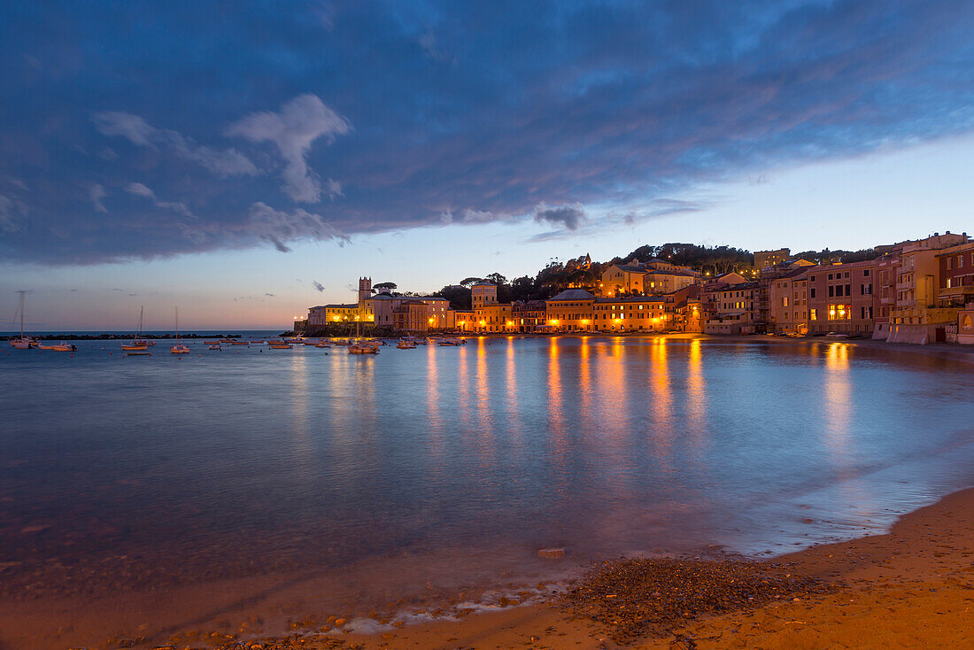 'Buildings Illuminated At Night Along The Water's Edge In Cinque Terre; Sestri Levante, Ligurian, Italy'