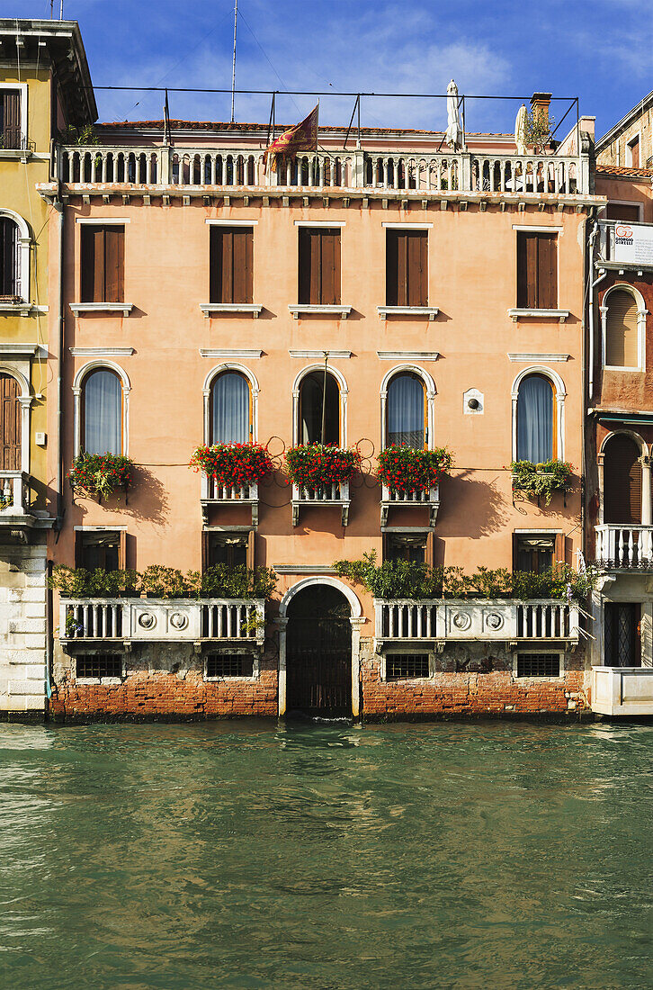 'A Yellow Residential Building Along The Grand Canal; Venice, Italy'