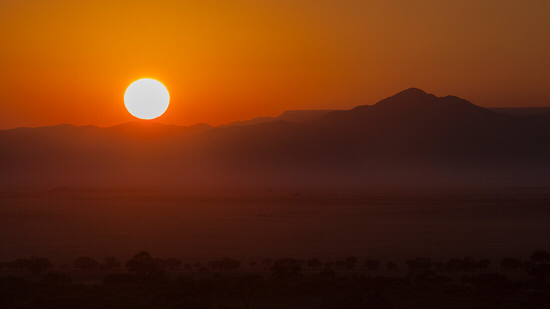 'Sunrise With A Silhouette Of The Landscape; Namibia'