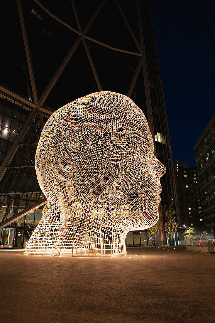 'White Metal Sculpture Of A Head At Night With Lights (Wonderland); Calgary, Alberta, Canada'