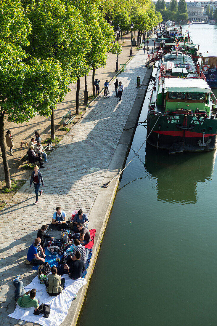 Relaxed atmosphere and strolling on the banks of la villette lake in spring, canal de l‚äôourcq, 19th arrondissement, paris, france