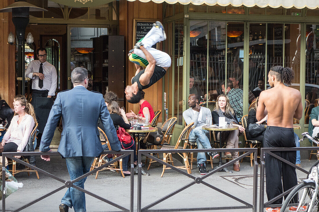 Acrobats at a sidewalk caf?â, avenue de grenelle, 15th arrondissement, paris, france