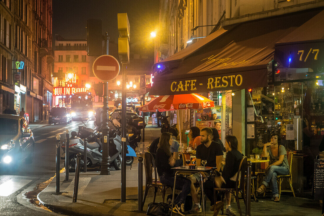 Street ambiance with customers on the terrace, parisian cafe restaurant at night, rue blanche, paris (75), france
