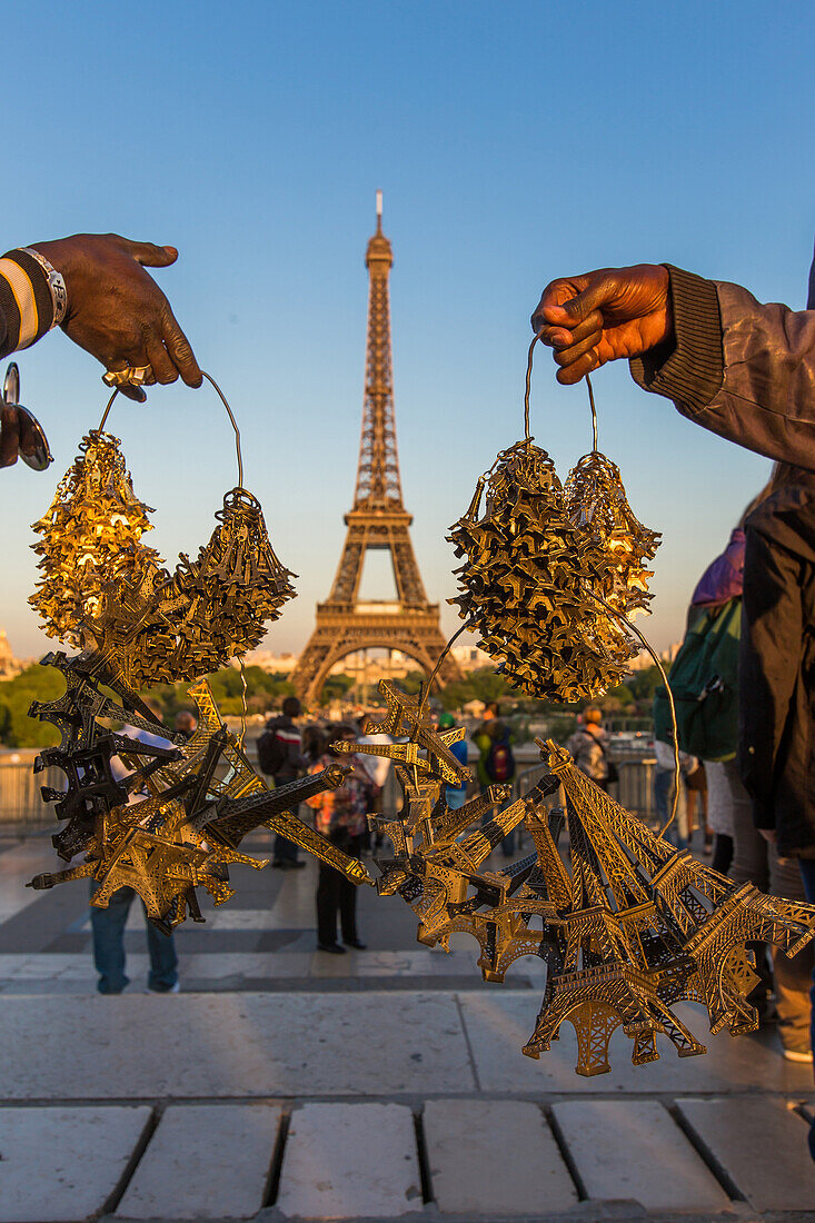 Street peddlers selling miniature eiffel towers near the eiffel tower, paris, france