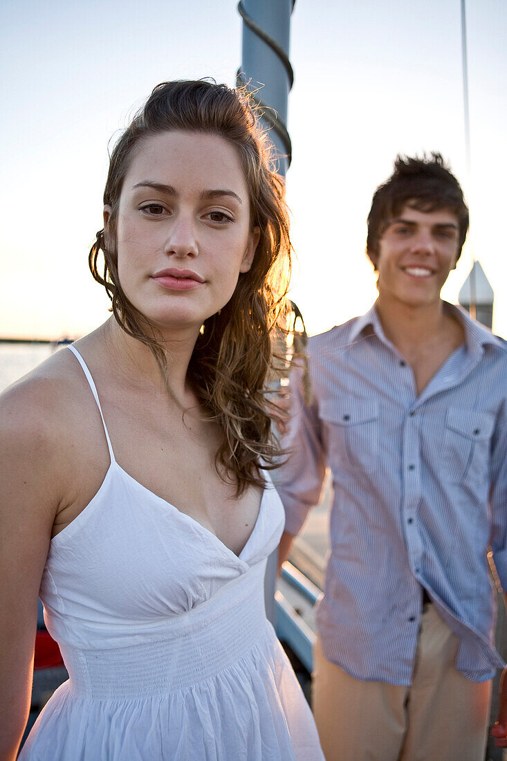 Young Woman on Boat, Portrait, With Smiling Young Man in Background