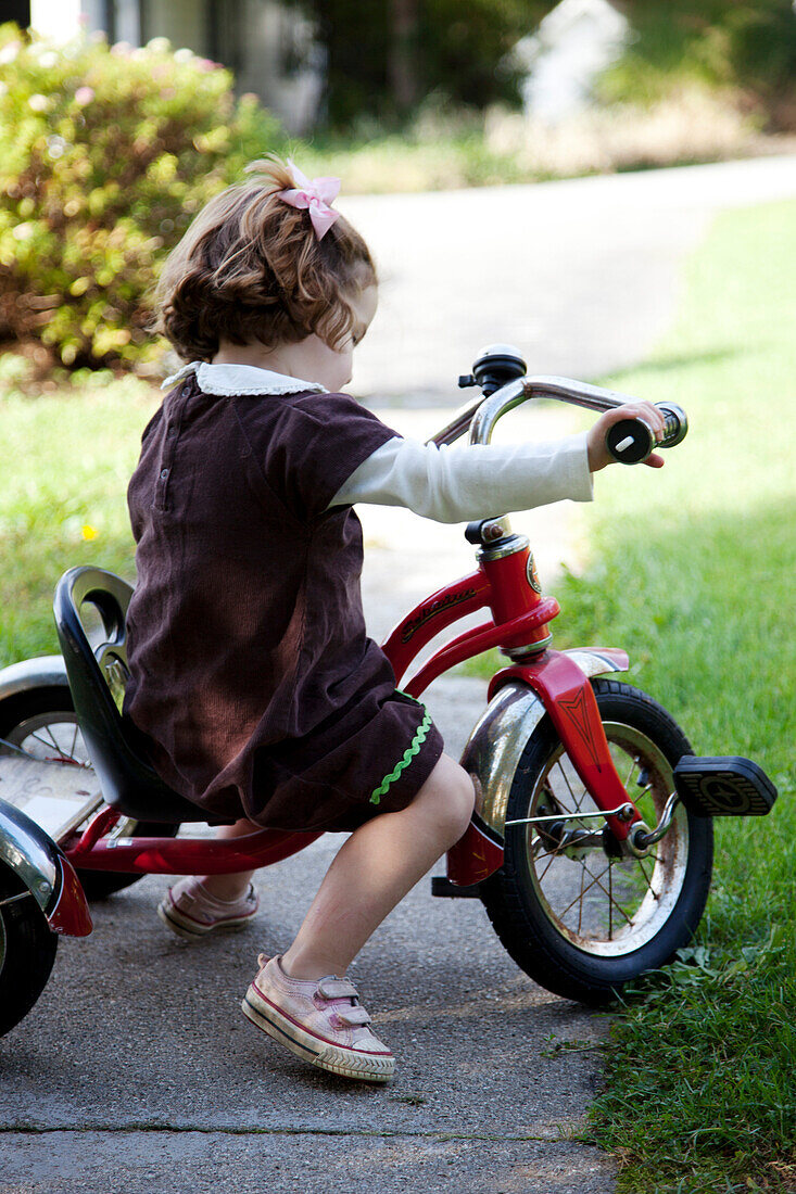 Young Girl Riding Tricycle, Profile