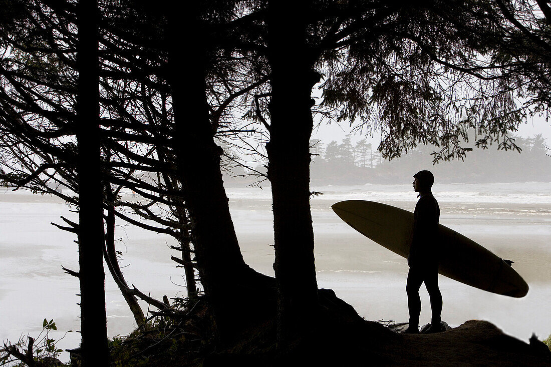 Silhouette Of A Surfer Looking Out To The Water