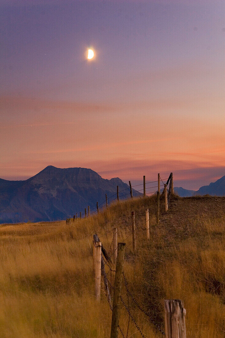 Fence And Early Evening Moonrise, Waterton Lakes National Park, Alberta