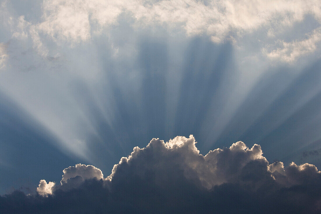 Sunlight Shining Up Out Of Clouds