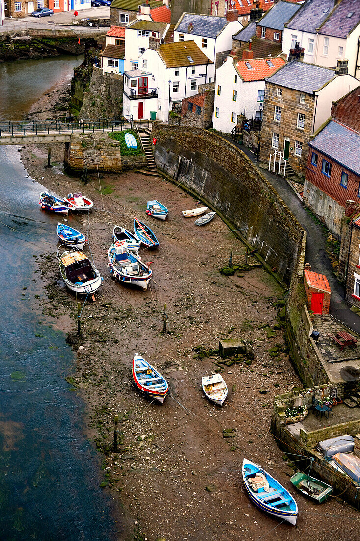 Boats Beached On The Riverbank, Staithes, North Yorkshire, England