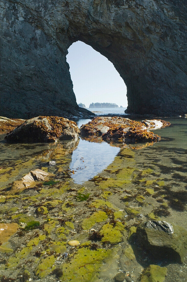 'Olympic National Park, Washington, United States Of America; Hole-In-The-Wall Reflected In The Water'