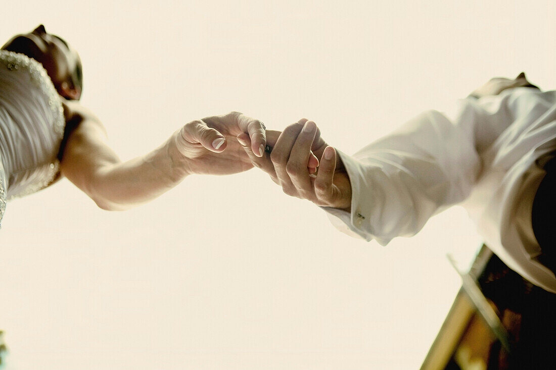 A Bride And Groom Holding Hands