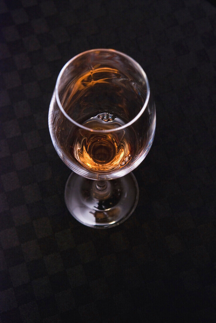 A Small Amount Of White Wine In The Bottom Of A Wine Glass