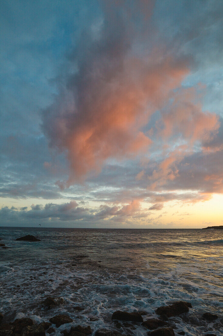 Sunset Light In The Clouds Over A Rocky Shore