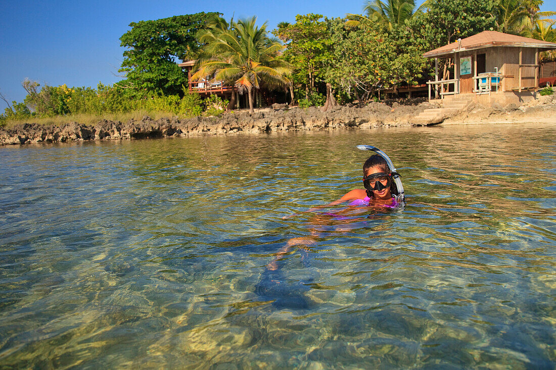 'Roatan, Bay Islands, Honduras; A Young Woman Snorkeling At Anthony's Key Resort'