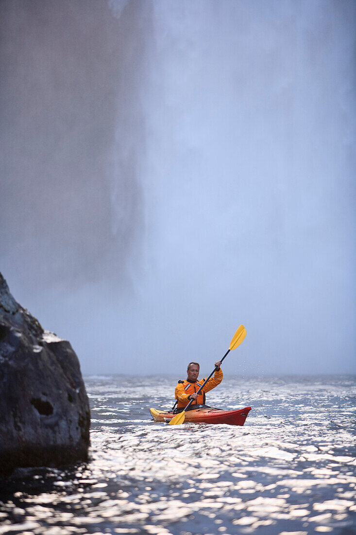 'Washington, United States Of America; A Man Kayaking Near Snoqualmie Falls'
