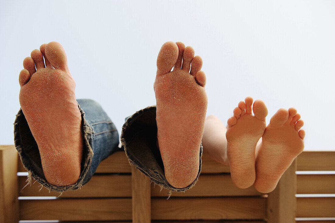 'Bare Feet Propped Up On A Bench At Los Lances Beach Along Costa De La Luz; Tarifa, Cadiz, Andalusia, Spain'