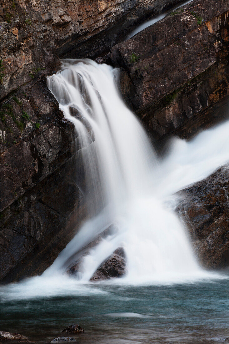 'Waterfalls Coming Out Of A Rock Cliff; Waterton, Alberta, Canada'