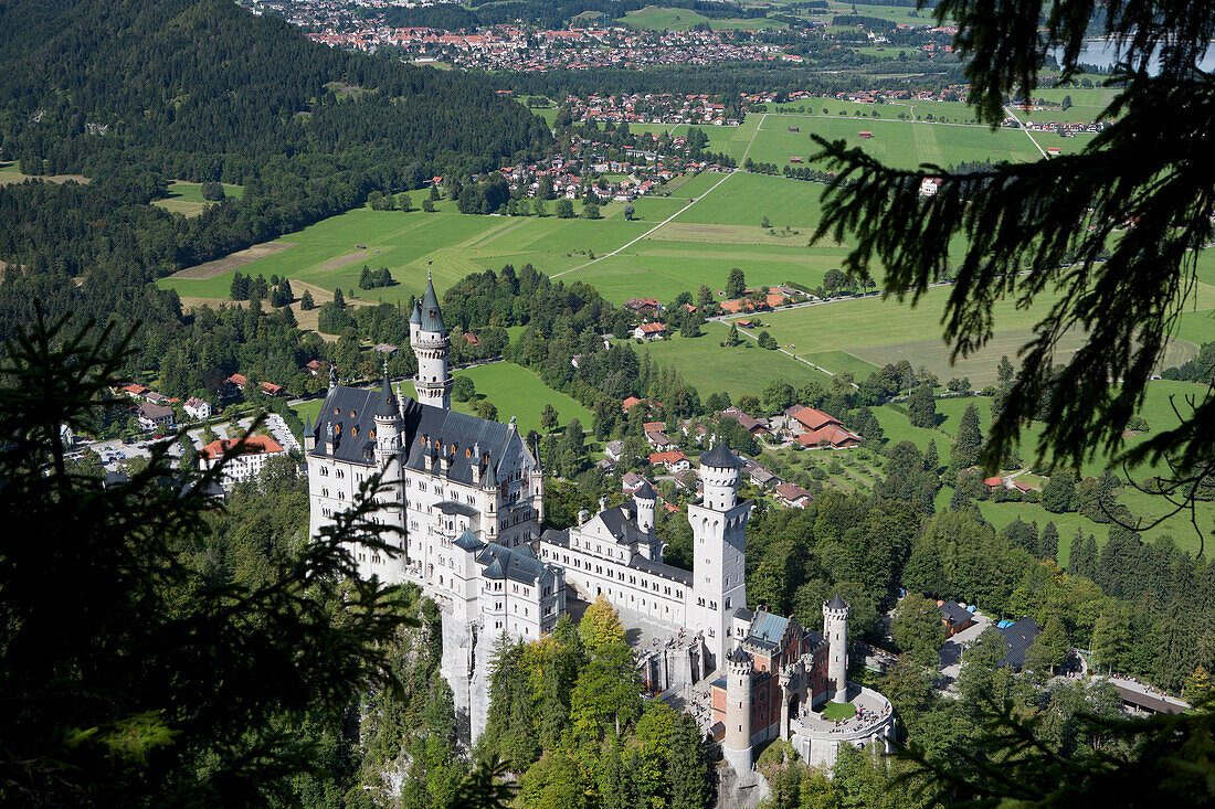 'Bavarian Castle On A Mountain Side With Fields And A Village In The Background; Fussen, Germany'